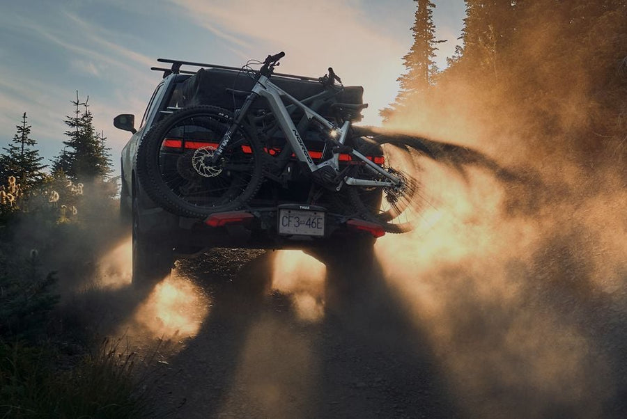 Vehicle with a hitch bike rack on a dirt road