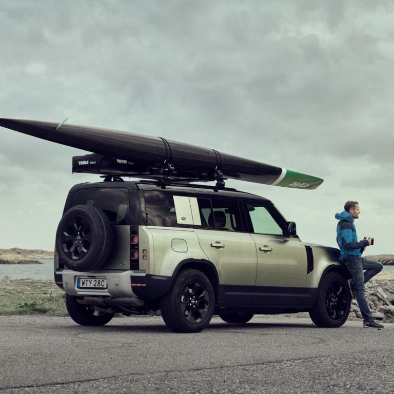 SUV carrying a kayak on a roof rack