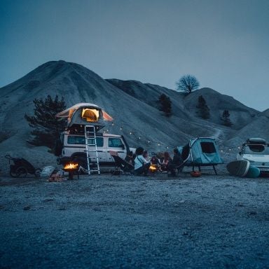 Rooftop tents set up at camp at dusk